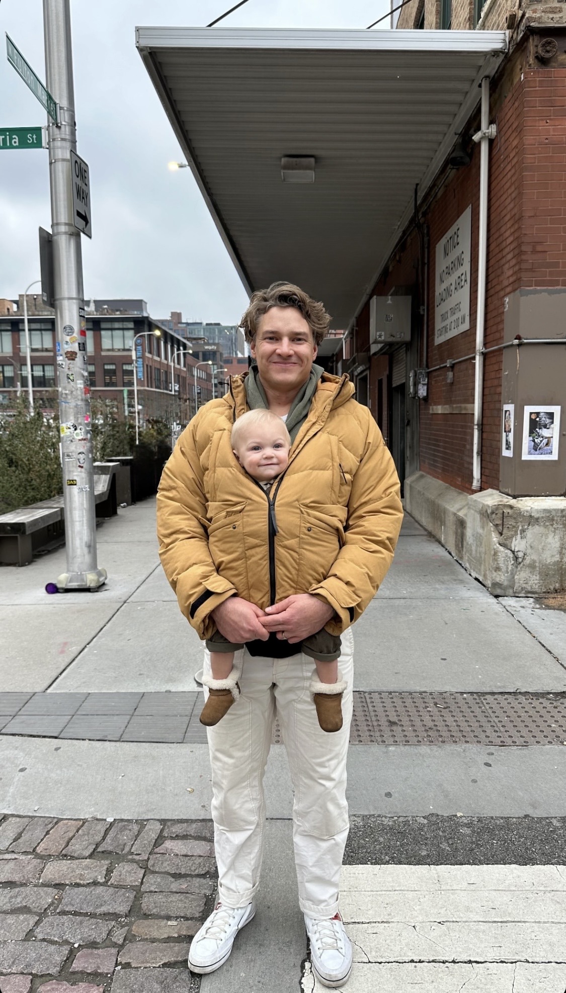 Brad Jackson holding his son on a Denver sidewalk